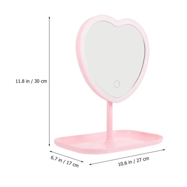 Miroir de maquillage en forme de cœur avec éclairage LED et support intégré pour ranger les accessoires.