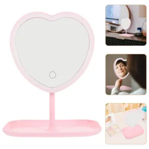 Miroir de maquillage en forme de cœur avec éclairage LED et support intégré pour ranger les accessoires.