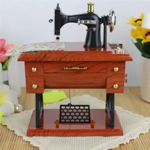 Mini machine à coudre décorative vintage en bois et métal, parfaite pour une décoration rétro et élégante.