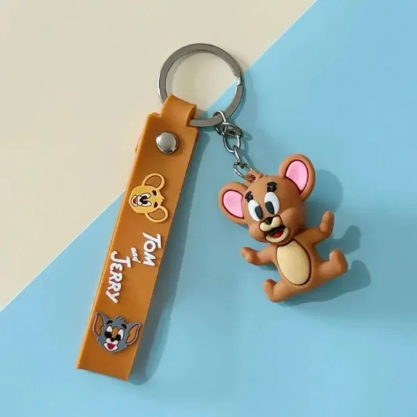 Porte clés Tom et Jerry avec figurine en silicone et lanière bleue décorative.