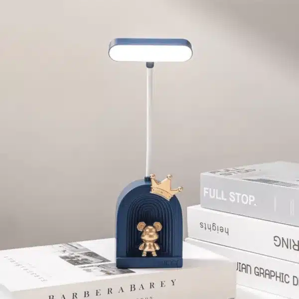 Lampe de bureau LED avec figurine dorée et base colorée