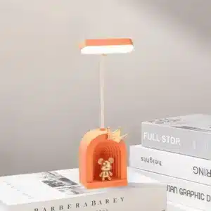 Lampe de bureau LED avec figurine dorée et base colorée
