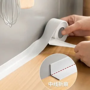 Ruban d’étanchéité autocollant blanc coupé avec des ciseaux pour la cuisine