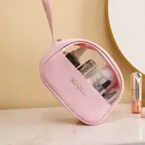 Trousse de maquillage rose avec fenêtre transparente et produits cosmétiques à l’intérieur