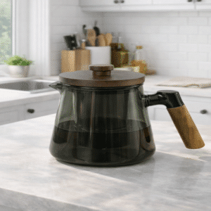 Théière en verre design poignée bois moderne posée sur plan de travail cuisine