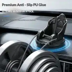 Support téléphone noir rotatif à 360 degrés fixé sur le tableau de bord d'une voiture avec base antidérapante.