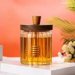 Pot à miel en verre avec cuillère intégrée et couvercle en bois