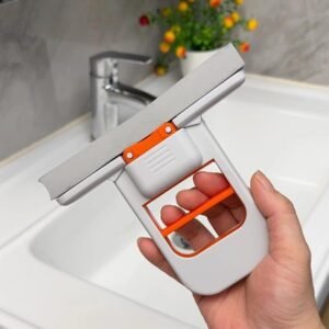 Raclette de nettoyage multifonction 2 en 1 pliable avec lame grise et poignée blanche et orange pour vitres, miroirs, carrelage et cuisine.